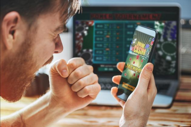 A man playing a casino game on his smartphone