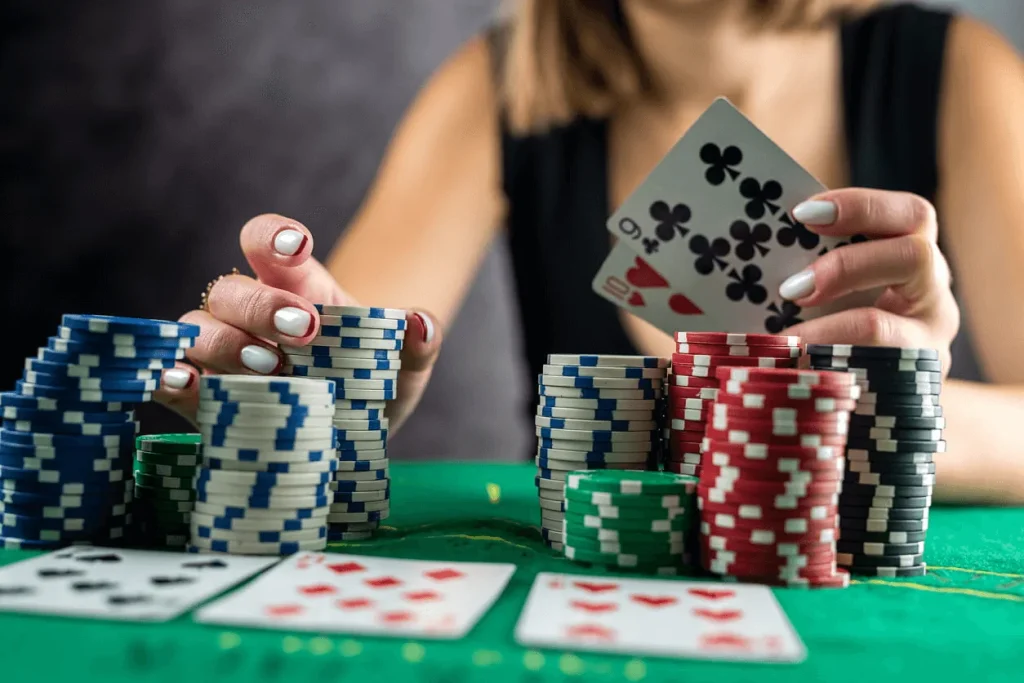 A woman holds a pair of playing cards
