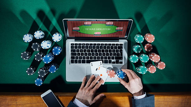 Close-up of a person at a laptop playing poker